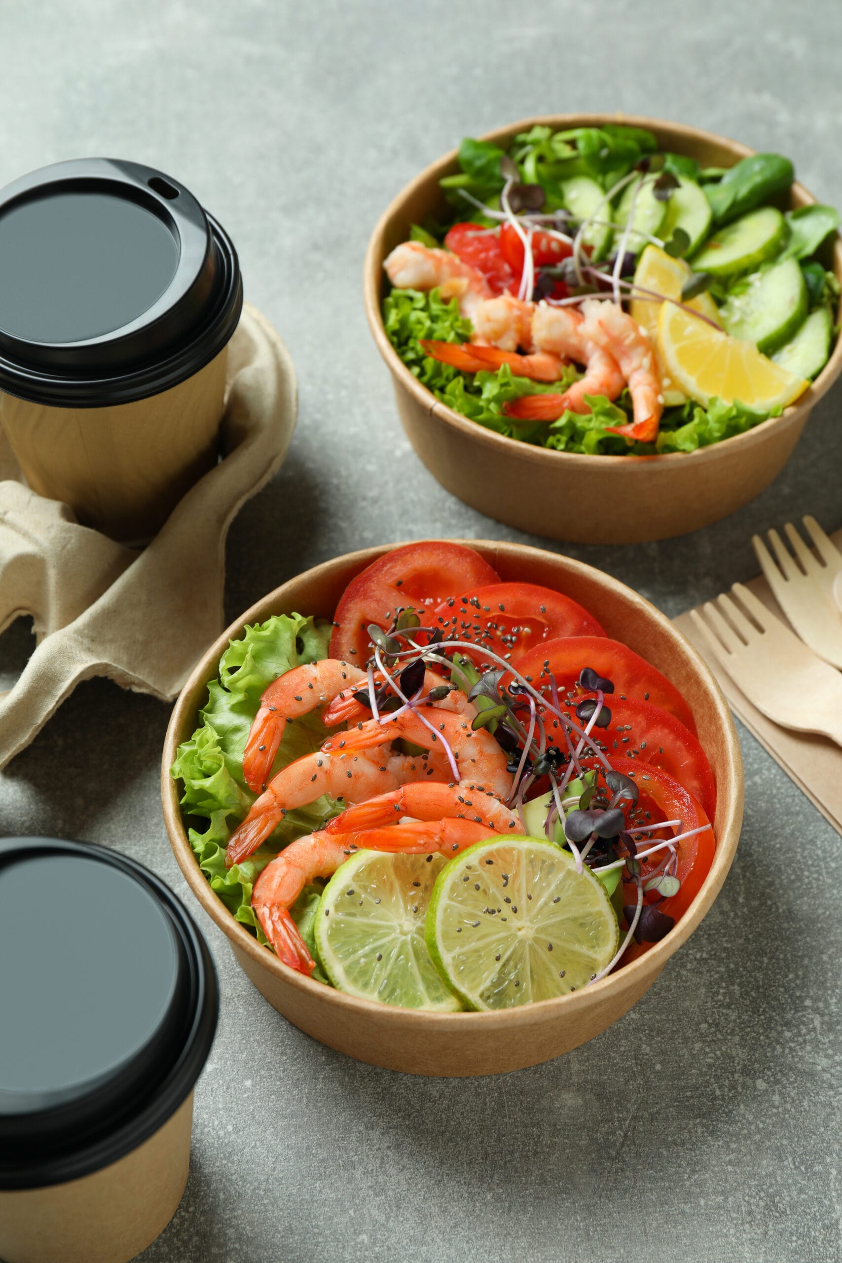 Concept of tasty eating with shrimp salads on gray table